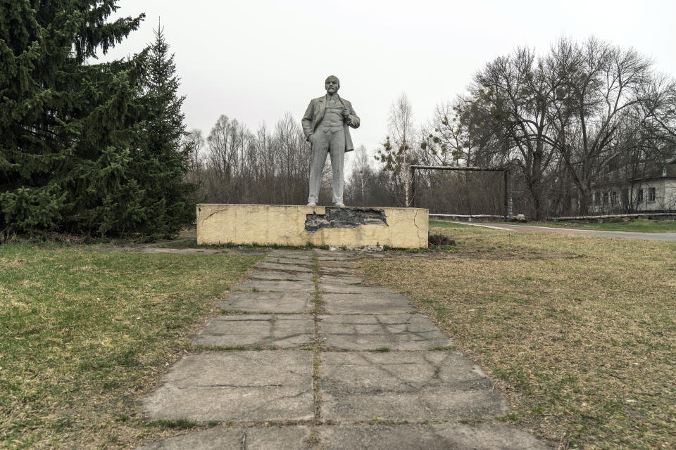 The monument of the Soviet State founder Vladimir Lenin is seen at the Chernobyl exclusion zone, Ukraine, Tuesday, April 13, 2021. TThe vast and empty Chernobyl Exclusion Zone around the site of the world’s worst nuclear accident is a baleful monument to human mistakes. Yet 35 years after a power plant reactor exploded, Ukrainians also look to it for inspiration, solace and income. (AP Photo/Evgeniy Maloletka)