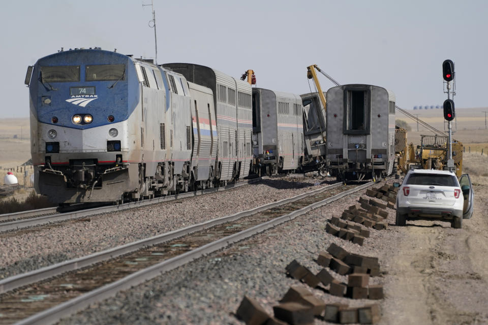 Engines and cars from an Amtrak train that derailed a day earlier are shown Sunday, Sept. 26, 2021, at the derailment site just west of Joplin, Mont. The crash killed three people and injured others. The westbound Empire Builder was en route to Seattle from Chicago, with two locomotives and 10 cars. (AP Photo/Ted S. Warren)