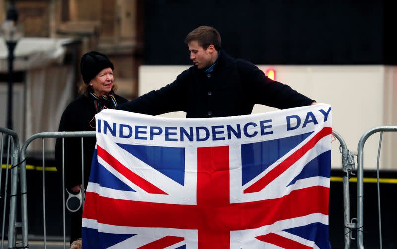 A man holds a Union Jack flag in London