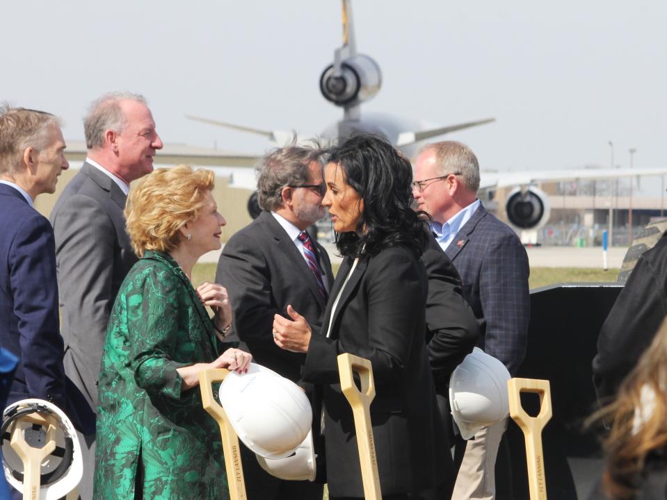 U.S. Sen. Debbie Stabenow and Nicole Noll-Williams, president and CEO of the Capital Regional Airport Authority, talk on a windy day at the Capital Region International Airport on April 11, 2023.
