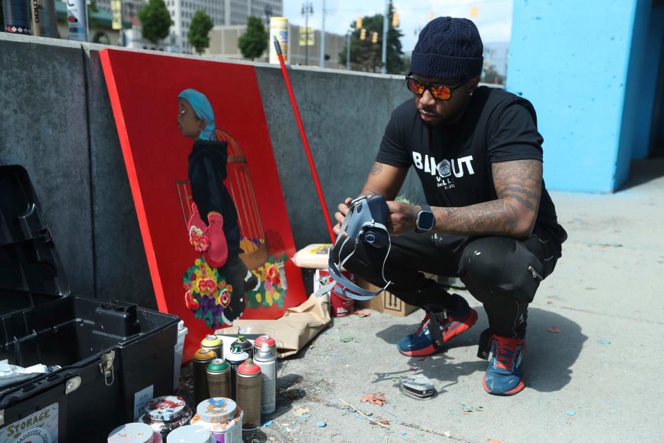 The BLKOUT Mural Festival hosted local and national artists along with some from the International scene to work on 25 murals around metro Detroit Monday, September 11, 2023. Oshun Williams from Detroit prepares to work his mural Growing Pains along Woodward Ave.