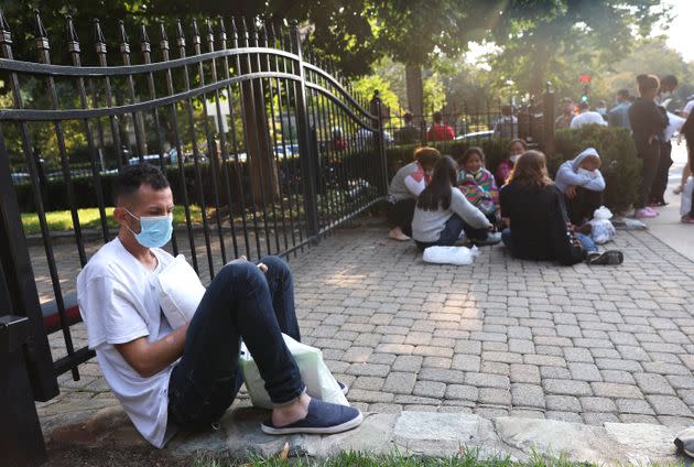 Migrants from Central and South America wait near the residence of Vice President Kamala Harris in Washington after being dropped off there on Sept. 15. (Photo: Kevin Dietsch via Getty Images)