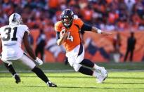 Sep 16, 2018; Denver, CO, USA; Denver Broncos quarterback Case Keenum (4) carries the football towards Oakland Raiders defensive back Marcus Gilchrist (31) in the fourth quarter at Broncos Stadium at Mile High. Mandatory Credit: Ron Chenoy-USA TODAY Sports