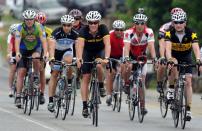 Lance Armstrong (center) leads the pack coming to Jack's restaurant in Pleasant Grove, Ala., Friday, April 27, 2012,, on the fourth day of the Bo Bikes Bama charity bike ride on the one-year anniversary of the deadly Alabama tornadoes. Bo Jackson and about 140 bicyclists and the celebrity bikers rode from Cordova, Ala. to Bessemer, Ala. on Friday. (AP Photo/The News, Linda Stelter) MAGS OUT