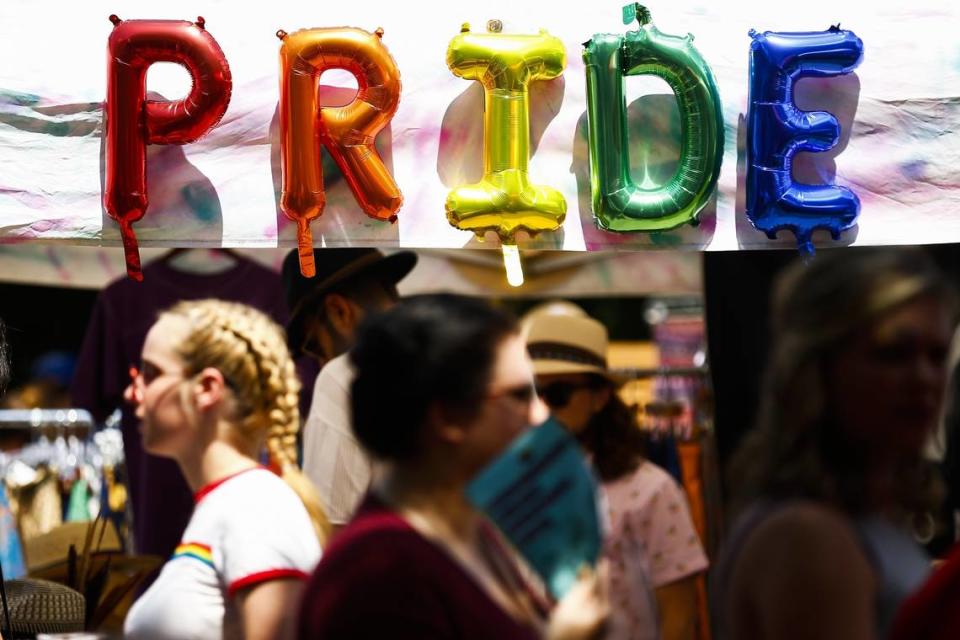 Thousands of attendees pass by pride balloons during Lexington Pride Festival 2018 Saturday at courthouse plaza in Lexington.