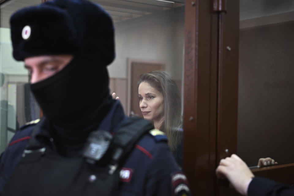 Antonina Favorskaya stands in a glass cage in a courtroom in the Basmanny District Court in Moscow, Russia, Friday, March 29, 2024. A court in Moscow makes a decision on measure of restrain to journalist Antonina Favorskaya in the case of her connection with the FBK, the Anti-Corruption Foundation set up by Russian opposition leader Alexei Navalny in 2011 and declared extremist and closed in 2021. (AP Photo/Dmitry Serebryakov)