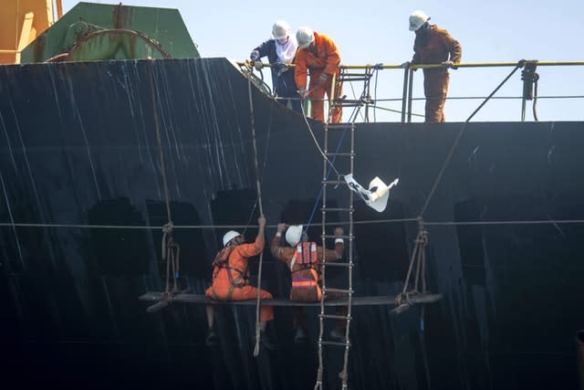 Crew members rename the ship