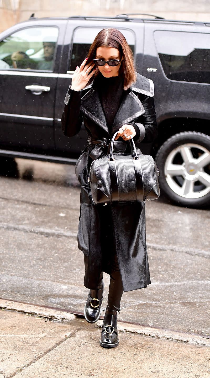 <p>In a black leather-lined trench coat with a Givenchy handbag, patent leather ankle boots and black sunglasses while out in New York City. </p>