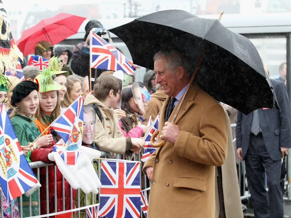 Prince Charles holds an umbrella on a walkabout in Norway