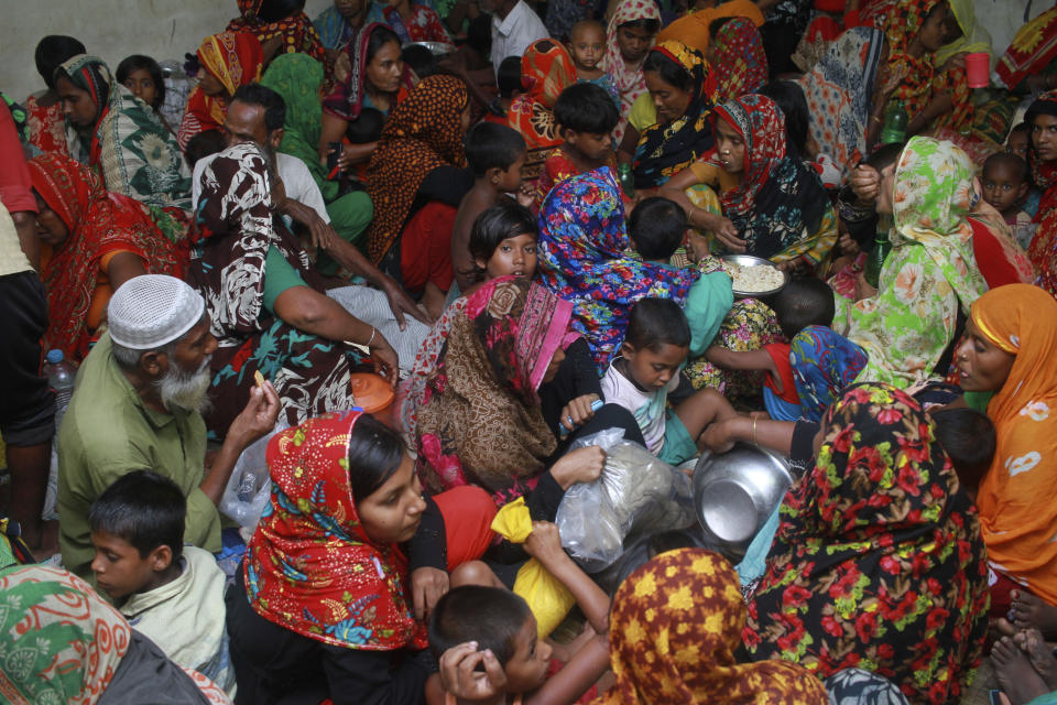 In this Wednesday, May 20, 2020 photo, people crowd a shelter before Cyclone Amphan made landfall, in Shyamnagar, Shatkhira, Bangladesh. A powerful cyclone that slammed into coastal India and Bangladesh has left damage difficult to assess Thursday. (AP Photo/Abu Sufian Jewel)