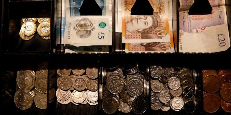 FILE PHOTO: Pound Sterling notes and change are seen inside a cash register in a coffee shop in Manchester, Britain, September 21, 2018. REUTERS/Phil Noble/File Photo