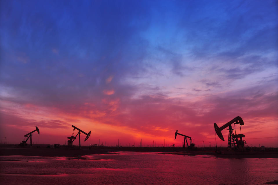 Oil pumps beneath a red and blue sky.