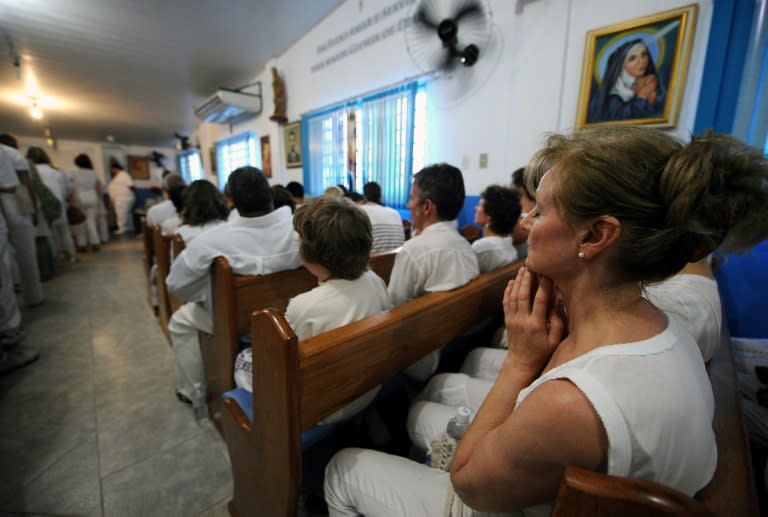 Patients pray at Joao's "Casa de Dom Inacio de Loyola" (House of Don Ignacio de Loyola), which attracts nearly 10,000 visitors each month, 40 percent of them from abroad