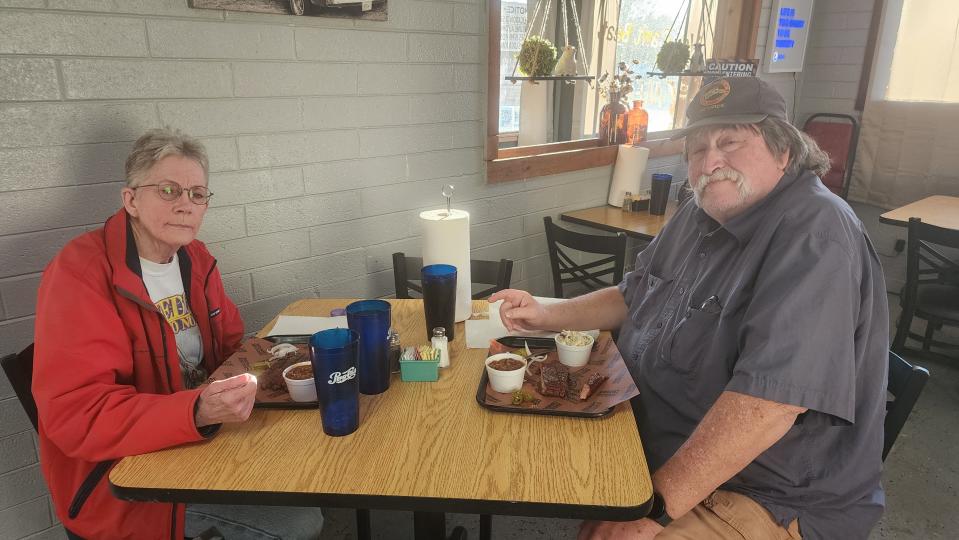 A couple enjoys a meal at Nine Line BBQ on Hillside Road.