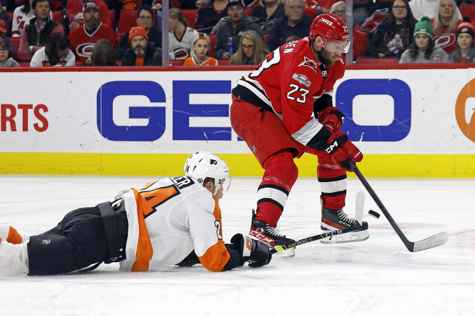 Philadelphia Flyers' Nick Seeler (24) dives to tip the puck away from Carolina Hurricanes' Stefan Noesen (23) during the second period of an NHL hockey game in Raleigh, N.C., Thursday, March 9, 2023. (AP Photo/Karl B DeBlaker)