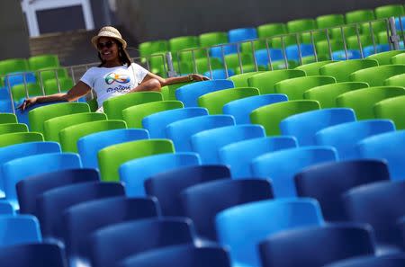 2016 Rio Olympics - Rowing - Repechage - Men's Single Sculls Repechages - Lagoa Stadium - Rio De Janeiro, Brazil - 07/08/2016. A spectator sits in the near empty seats after competition was postponed. REUTERS/Murad Sezer