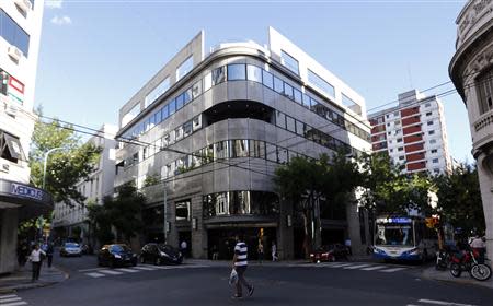 A man crosses the street in front of the Argentine Institute for Diagnosis and Treatment private clinic, where philanthropist and former media tycoon Ted Turner is being treated in Buenos Aires March 7, 2014. REUTERS/Marcos Brindicci