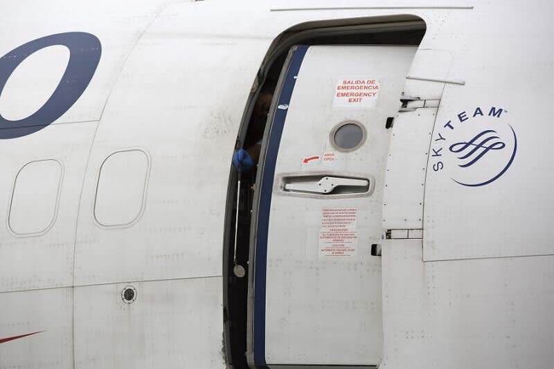 The woman tried to open the plane door (pictured by stock image) and jump out. [Photo: Getty]
