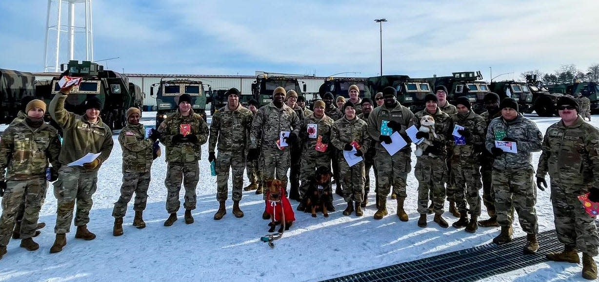 U.S. soldiers on assignment in South Korea hold up holiday messages from Barberton Intermediate School students. More than 200 students at the school participated in the activity, receiving photos and videos thanking the students.