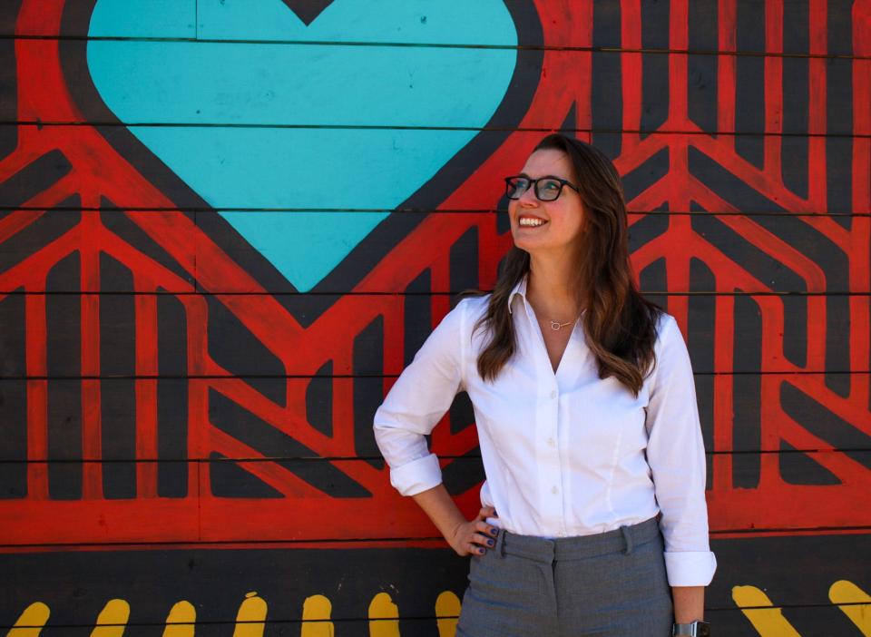 Renee Duxler stands by a mural in downtown Salina, Kansas. Duxler was named the new president and CEO of the Salina Area Chamber of Commerce.