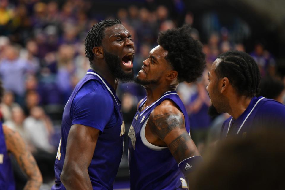 Washington center Franck Kepnang, left, and forward Keion Brooks Jr. celebrate during the Huskies' upset of Gonzaga at Alaska Airlines Arena.