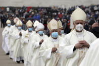 Clerics wear face masks while taking part in a procession in a procession before a mass during ceremonies at the Catholic shrine in Fatima, Portugal, Thursday, May 13, 2021. In view of the coronavirus pandemic, the shrine has limited to 7,500 the number of pilgrims that can be present during this year's May 12 and 13 celebrations usually attended by hundreds of thousands. (AP Photo/Ana Brigida)