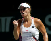 Tennis - Singapore WTA Finals Singles - National Indoor Stadium, Singapore - 23/10/2016 - Angelique Kerber of Germany celebrates a point against Dominika Cibulkova of Slovakia. REUTERS/Edgar Su