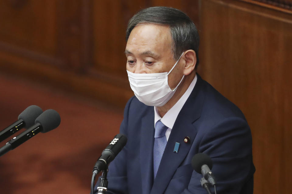 Japanese Prime Minister Yoshihide Suga delivers a policy speech during an extraordinary Diet session at the upper house of parliament in Tokyo, Monday, Oct. 26, 2020. Suga has declared Japan will achieve zero carbon emissions by 2050 in his first policy speech after taking over from Shinzo Abe. The policy speech Monday at the outset of the parliamentary session set an ambitious agenda reflecting Suga's pragmatic approach to getting things done. (AP Photo/Koji Sasahara)