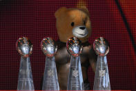 FILE - Kansas City Chiefs linebacker Willie Gay, wearing a teddy bear head, stands behind the Chiefs' four Vince Lombardi trophies during their victory rally in Kansas City, Mo., Wednesday, Feb. 14, 2024. The Chiefs defeated the San Francisco 49ers Sunday in the NFL Super Bowl 58 football game. (AP Photo/Reed Hoffmann, File)