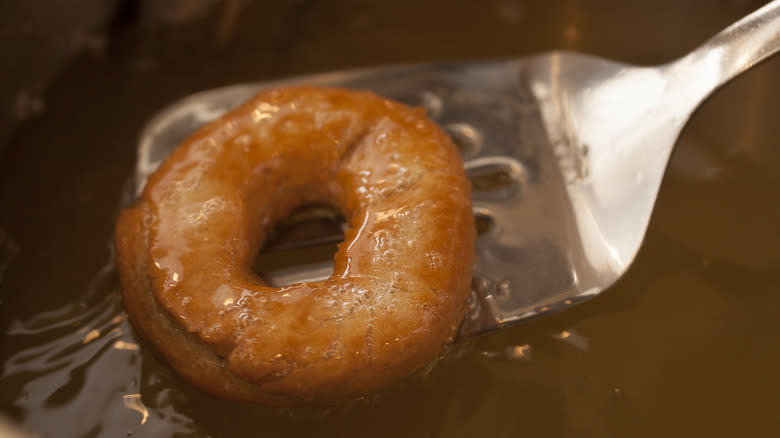 donut being lifted from oil