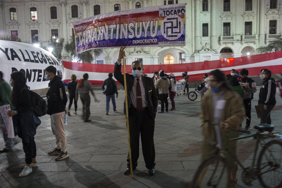 People gather in San Martin square after Peru's new interim President Francisco Sagasti was designated by Congress to lead the nation, in Lima, Peru, Monday, Nov. 16, 2020. Lawmakers chose Sagasti to become the nation's third president in the span of a week after they ousted Martin Vizcarra and the following protests forced his successor Manuel Merino to resign. (AP Photo/Rodrigo Abd)