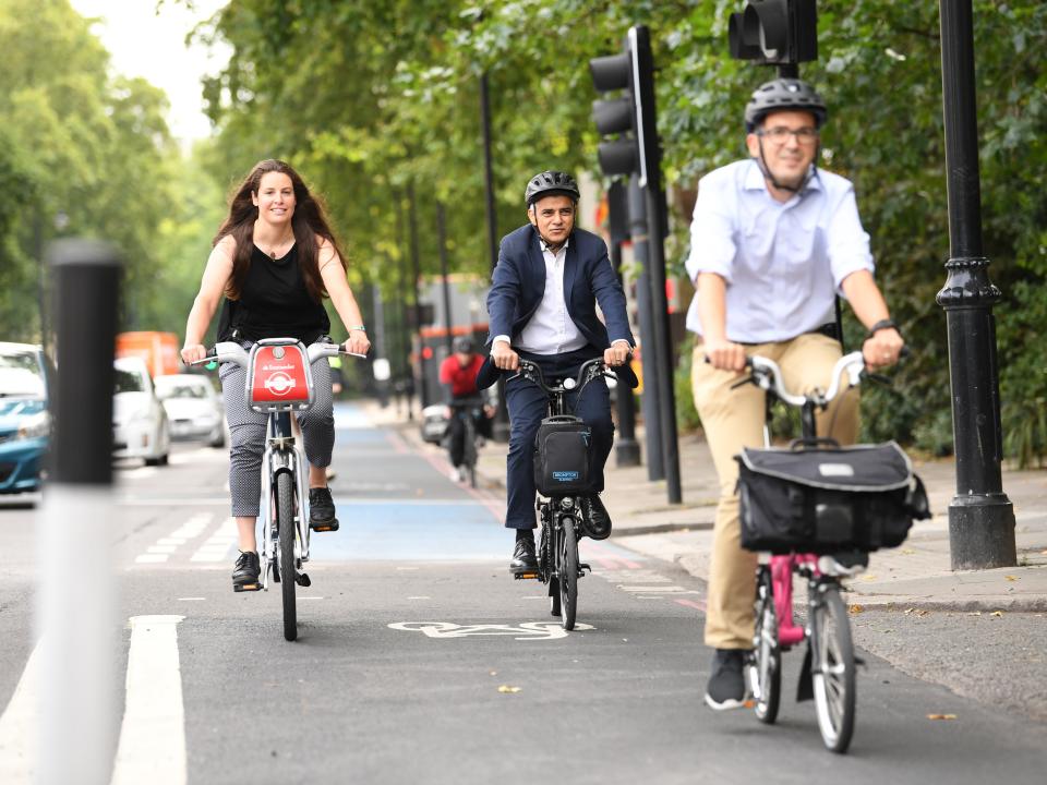 Mayor of London Sadiq Khan (centre) tries out a protected cycle lane alongside Will NormanPA