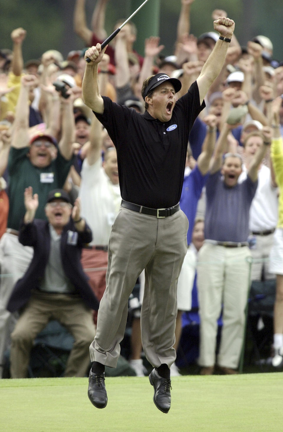 FILE - This photo by Associated Press photographer Elise Amendola shows Phil Mickelson celebrating after winning the Masters golf tournament with a nine-under-par at the Augusta National Golf Club in Augusta, Ga., Sunday, April 11, 2004. Amendola, who recently retired from the AP, died Thursday, May 11, 2023, at her home in North Andover, Mass., after a 13-year battle with ovarian cancer. She was 70. (AP Photo/Elise Amendola, File)