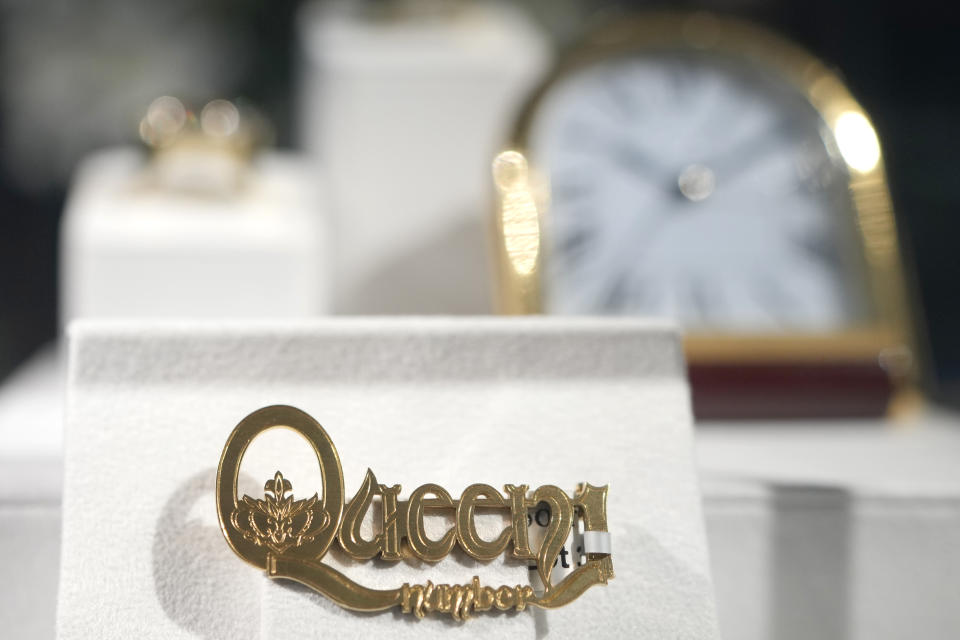 One of only four made Cartier, London 'Queen Number 1' gold brooch, 1975 is displayed at Sotheby's auction rooms in London, Thursday, Aug. 3, 2023. More than 1,400 of Freddie Mercury's personal items, including his flamboyant stage costumes, handwritten drafts of “Bohemian Rhapsody” and the baby grand piano he used to compose Queen's greatest hits, are going on show in a free exhibition at Sotheby's London ahead of their sale. (AP Photo/Kirsty Wigglesworth)