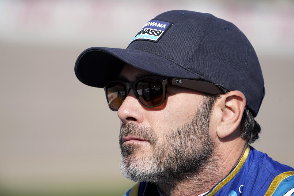 FILE - Jimmie Johnson stands near his car during qualifying for an IndyCar Series auto race, Saturday, July 23, 2022, at Iowa Speedway in Newton, Iowa. Noah Gragson has been known to puke in a race car and shotgun beers in victory celebrations. Behind the frivolity is a serious student of NASCAR, says new boss and teammate Jimmie Johnson. (AP Photo/Charlie Neibergall, File)