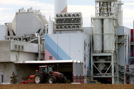 FILE PHOTO: A facility for capturing CO2 from air of Swiss Climeworks AG is placed on the roof of a waste incinerating plant in Hinwil, Switzerland July 18, 2017. REUTERS/Arnd Wiegmann/File Photo