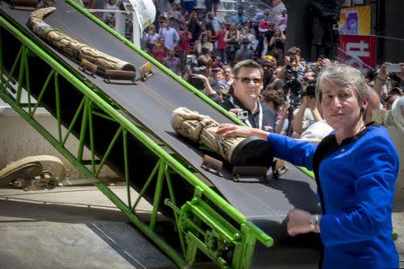 U.S. Secretary of the Interior Sally Jewell places a piece of confiscated ivory on to a belt to be crushed in New York's Times Square June 19, 2015. REUTERS/Brendan McDermid