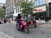 Delivery scooters are parked as drivers wait to pick up food for delivery, Thursday, June 6, 2024, in Boston. Boston and New York are cracking down on unlawful drivers, whom they say are ignoring traffic laws and making city streets more dangerous. (AP Photos/Michael Casey)