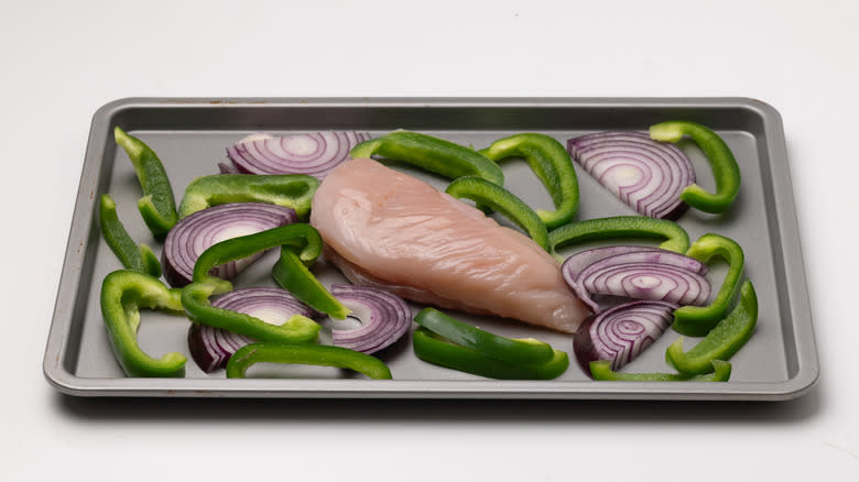 raw chicken and vegetables on tray