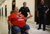 A protester in a wheelchair is escorted away from a demonstration outside Senate Majority Leader Mitch McConnell's Capitol Hill office after Senate Republicans unveiled their healthcare bill in Washington, U.S., June 22, 2017 REUTERS/Kevin Lamarque