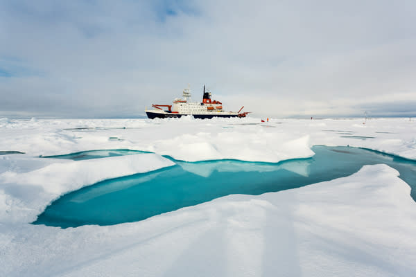 The German research ice breaker RV Polarstern next to a typical sea ice melt pond.