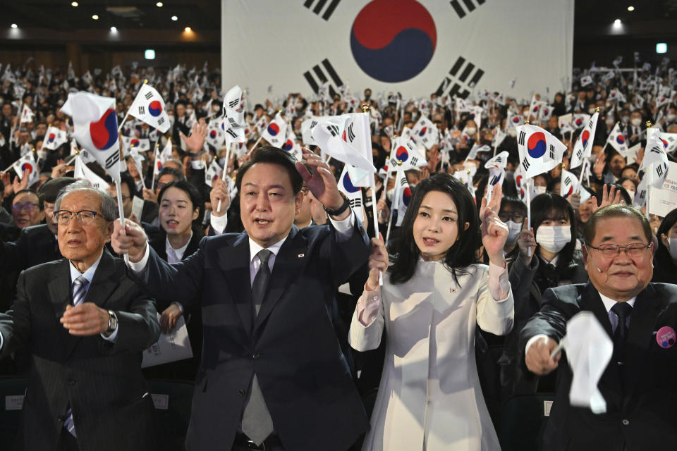 South Korea's President Yoon Suk Yeol, center left, and his wife Kim Keon Hee, center right, give three cheers during a ceremony of the 104th anniversary of the March 1st Independence Movement Day against Japanese colonial rule, in Seoul Wednesday, March 1, 2023. (Jung Yeon-je/Pool Photo via AP)