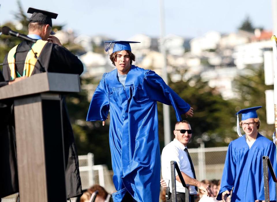 At Morro Bay High School, 180 grads were honored Thursday evening in a ceremony at the school’s football field. Dono Leahy does a little dance before receiving his diploma.