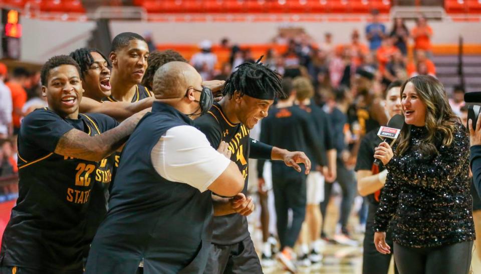 Wichita State’s Ricky Council IV is mobbed by teammates and coaches while being interviewed on ESPN after his big second half in the Shockers’ win at Oklahoma State.
