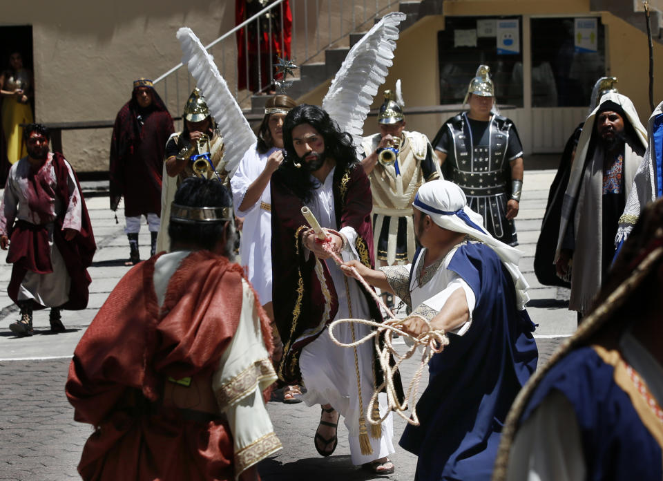 Brando Neri Luna plays the role of Jesus Christ during the Passion Play of Iztapalapa, outside the Cathedral, on the outskirts of Mexico City, Friday, April 2, 2021, amid the new coronavirus pandemic. To help prevent the spread of the COVID-19, Latin America's most famous re-enactment of the crucifixion of Christ was closed to the public and transmitted live so people could watch at home, for a second consecutive year. (AP Photo/Marco Ugarte)