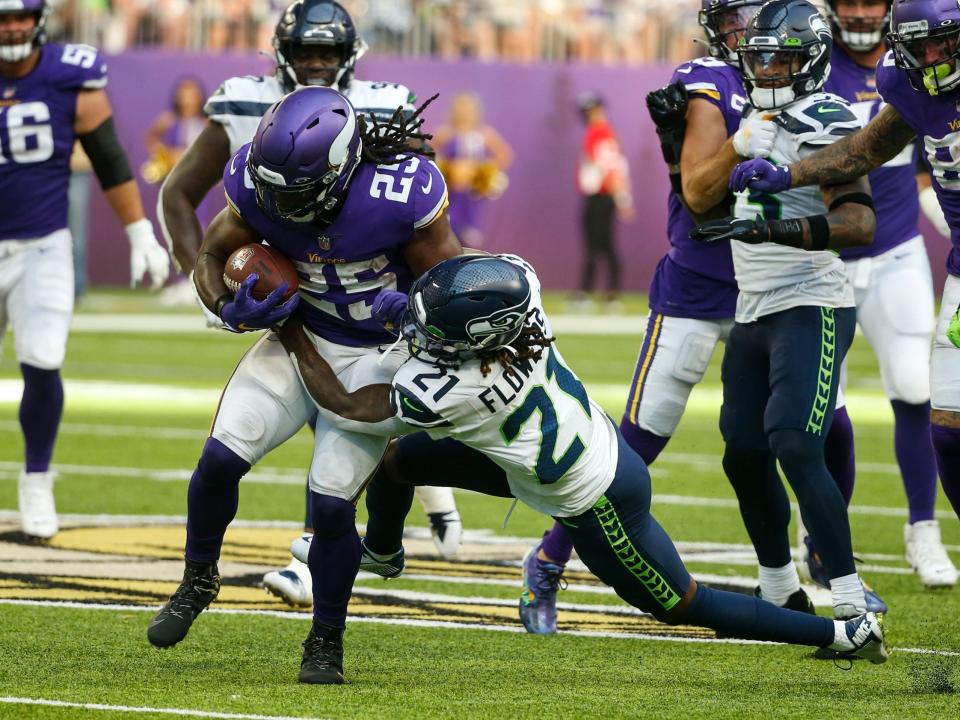 Alexander Mattison fights through a tackle against the Seattle Seahawks.