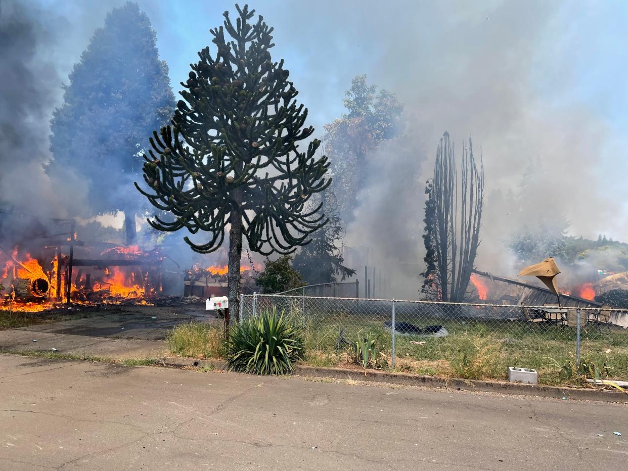 A pair of homes on Kremont Avenue burn amid a multi-structure fire in Springfield on Sunday, Aug. 7, 2022.