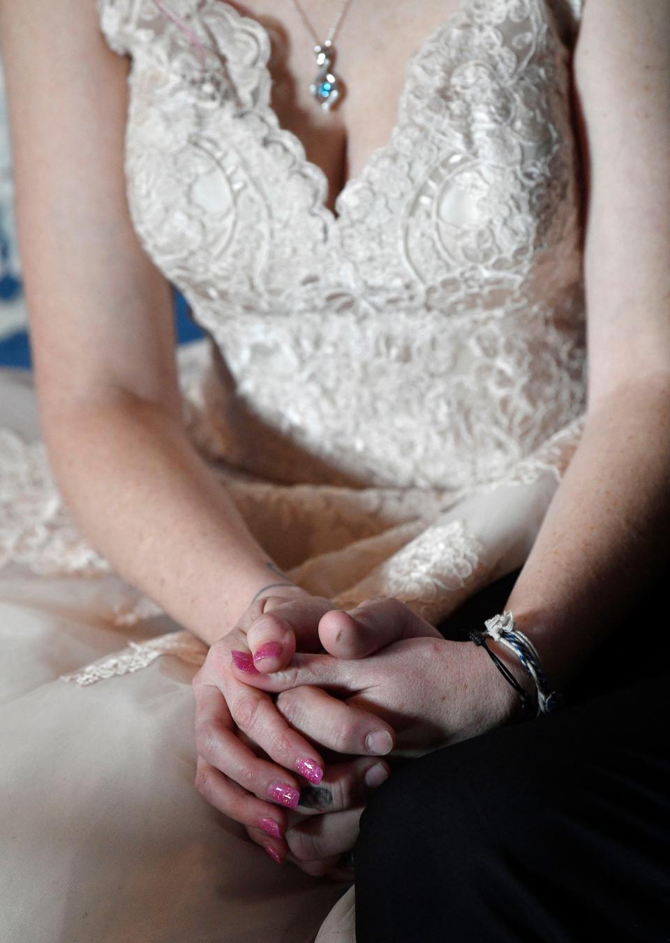 Amanda DiMarzio, and  Sean Woodard hold hands before their wedding Wednesday, Dec. 4, 2019, in Nashville, Tenn. A not-for-profit, Wish Upon a Wedding, put on the ceremony and reception at little cost to the bride and groom.