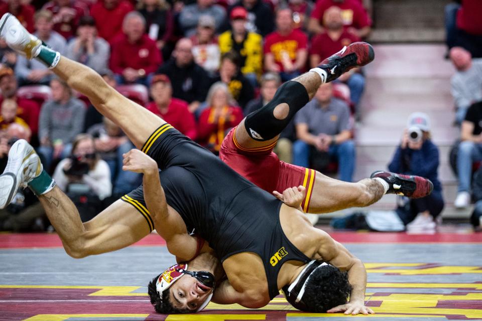 Iowa's Jesse Ybarra wrestles Iowa State's Kysen Terukina at 125, during the CyHawk dual, on Sunday, Dec. 5, 2021, at Hilton Coliseum, in Ames. 