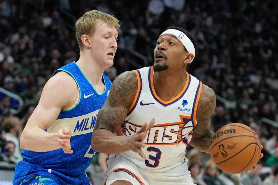 Phoenix Suns' Bradley Beal tries to get past Milwaukee Bucks' AJ Green during the first half of an NBA basketball game on March 17, 2024, in Milwaukee.